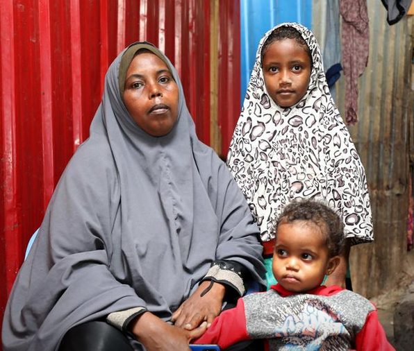 Muslim Mohamed Abdirahman is seen with her children during a Reuters interview after receiving the World Food Program (WFP) card for online shopping in Wabari district of Mogadishu, Somalia October 24, 2020. Picture taken October 24, 2020. REUTERS/Feisal Omar